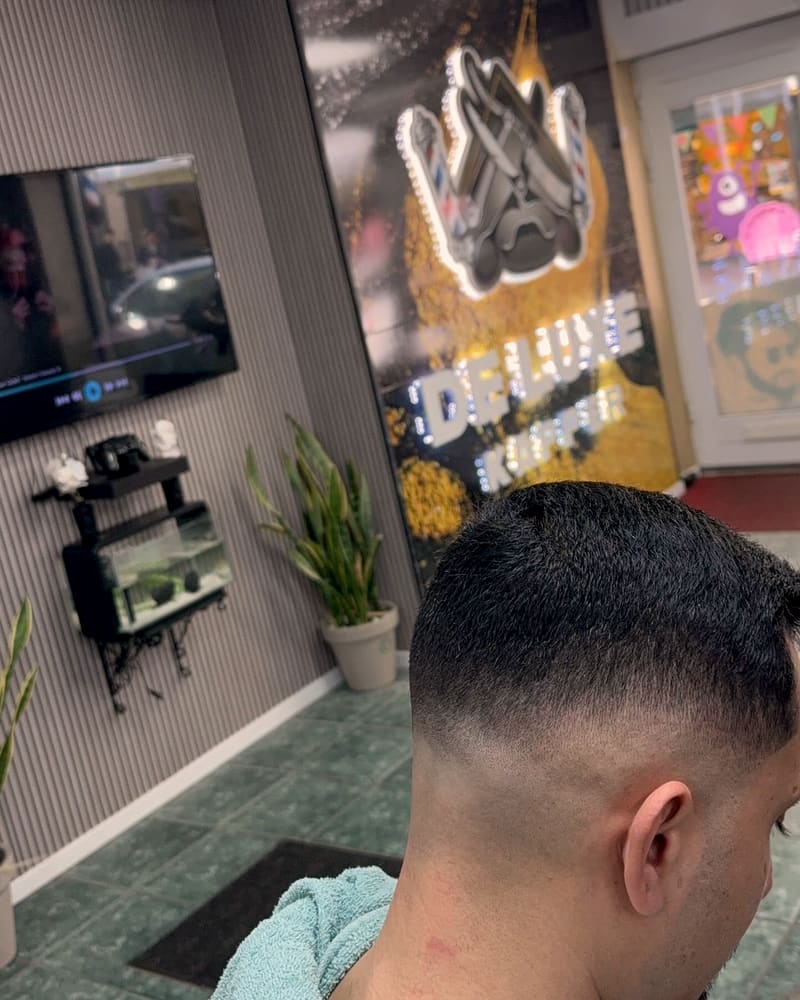 Skin fade met kort getextureerd bovenhaar, van achteren